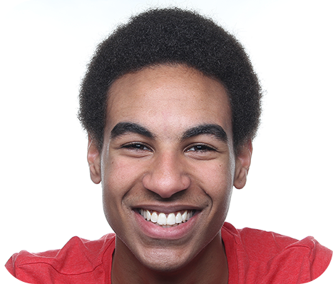 man in a red tee smiling in front of a white background