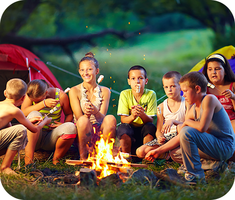 children roasting marshmellow during a camping trip