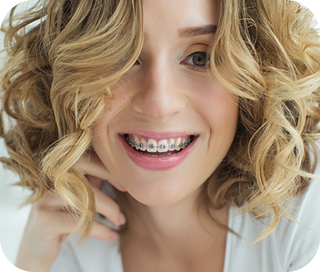 curly hair blond woman with braces